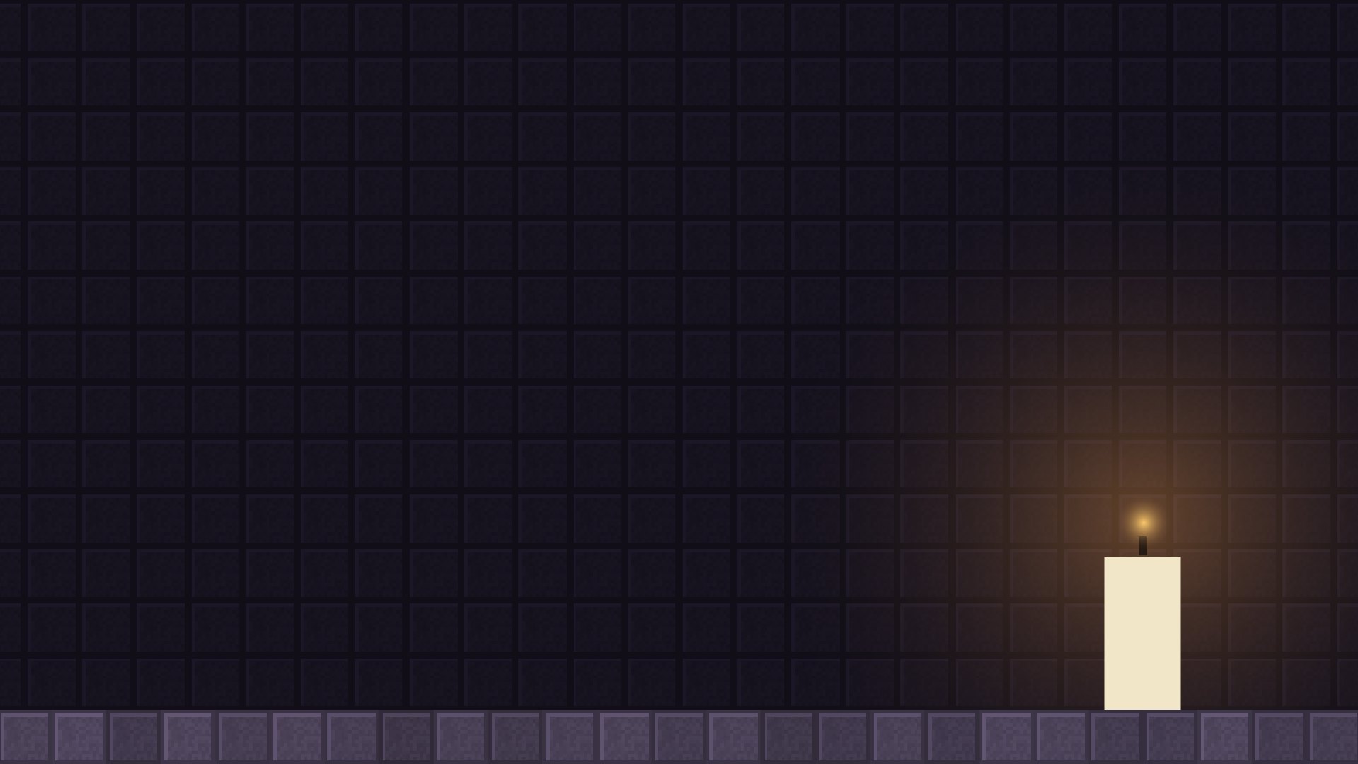 A lit candle on a stone floor in front of a dark brick wall
